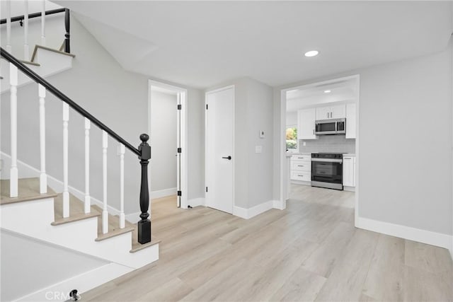 18684 Santa Ynez St, Fountain Valley, CA 92708 - foyer entrance featuring light wood finished floors, recessed lighting, and stairway