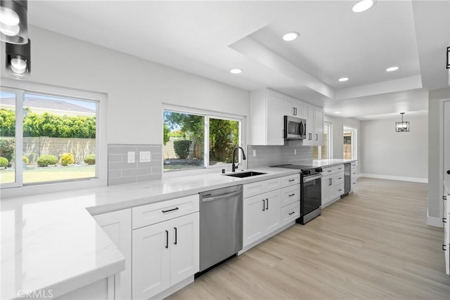 18684 Santa Ynez St, Fountain Valley, CA 92708 - kitchen featuring appliances with stainless steel finishes, recessed lighting, light stone countertops, healthy amount of natural light, and backsplash