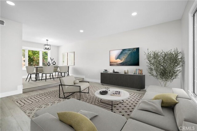 18684 Santa Ynez St, Fountain Valley, CA 92708 - living room with wood finished floors, recessed lighting, and a chandelier