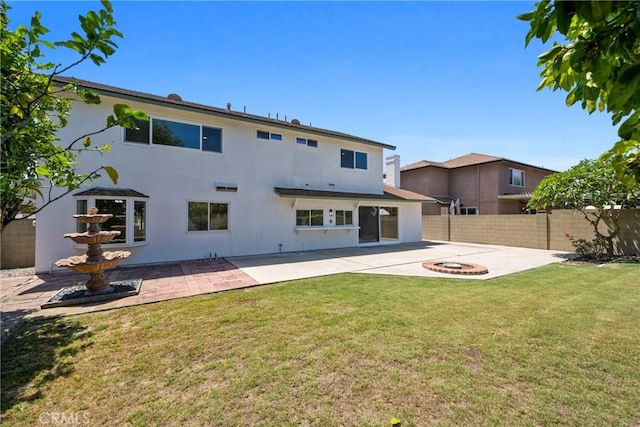 18684 Santa Ynez St, Fountain Valley, CA 92708 - back of house with a patio area, stucco siding, a fenced backyard, and a fire pit