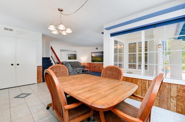 1403 Manzana Way, San Diego, CA 92139 - dining space featuring a chandelier, light tile patterned flooring, and stairway