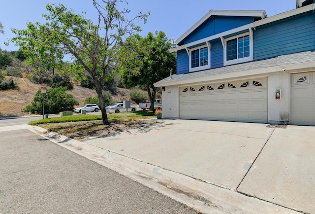 1403 Manzana Way, San Diego, CA 92139 - view of home's exterior featuring an attached garage, driveway, and roof with shingles