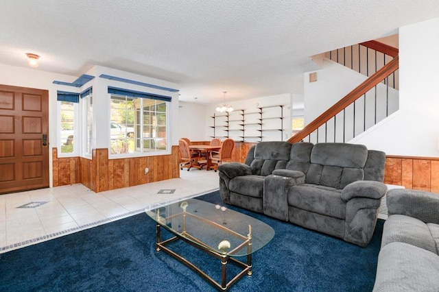 1403 Manzana Way, San Diego, CA 92139 - carpeted living room with wood walls, a wainscoted wall, stairway, a chandelier, and a textured ceiling