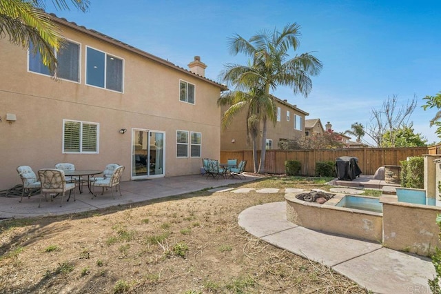 1702 Brezar St, Chula Vista, CA 91913 - rear view of property with a fire pit, a chimney, a fenced backyard, a patio area, and stucco siding
