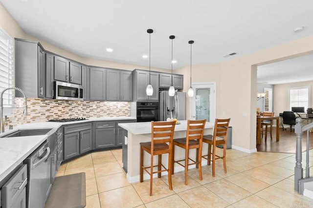 1702 Brezar St, Chula Vista, CA 91913 - kitchen featuring appliances with stainless steel finishes, gray cabinets, light tile patterned floors, tasteful backsplash, and recessed lighting