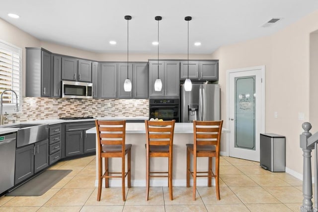 1702 Brezar St, Chula Vista, CA 91913 - kitchen featuring stainless steel appliances, gray cabinets, decorative backsplash, light tile patterned flooring, and recessed lighting