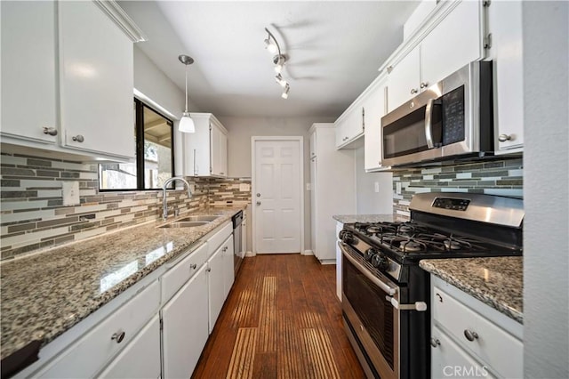 41015 163rd St E, Lancaster, CA 93535 - kitchen with stainless steel appliances, white cabinetry, decorative backsplash, light stone counters, and pendant lighting
