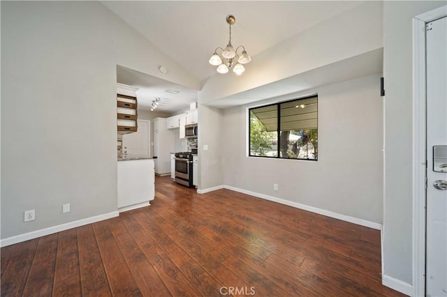 41015 163rd St E, Lancaster, CA 93535 - unfurnished living room featuring a chandelier, dark wood finished floors, and vaulted ceiling
