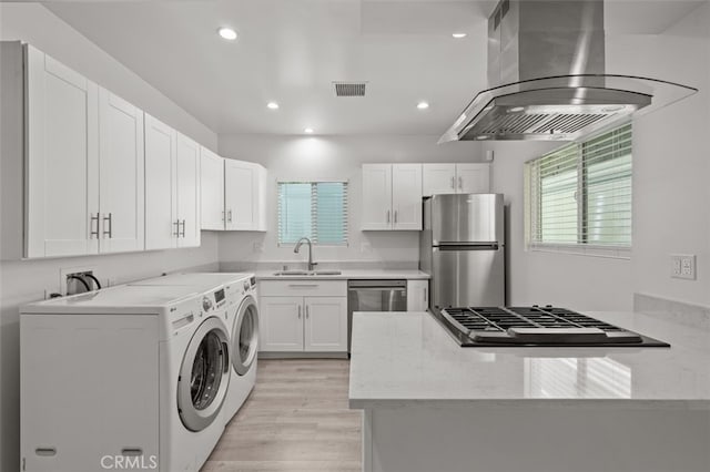 12424 Sarah St, Studio City, CA 91604 - laundry room featuring independent washer and dryer, light wood finished floors, and recessed lighting