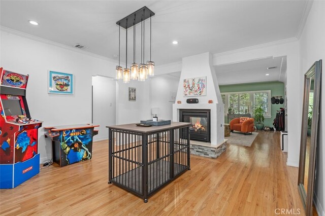 12424 Sarah St, Studio City, CA 91604 - dining area with light wood-style flooring, ornamental molding, a multi sided fireplace, and recessed lighting
