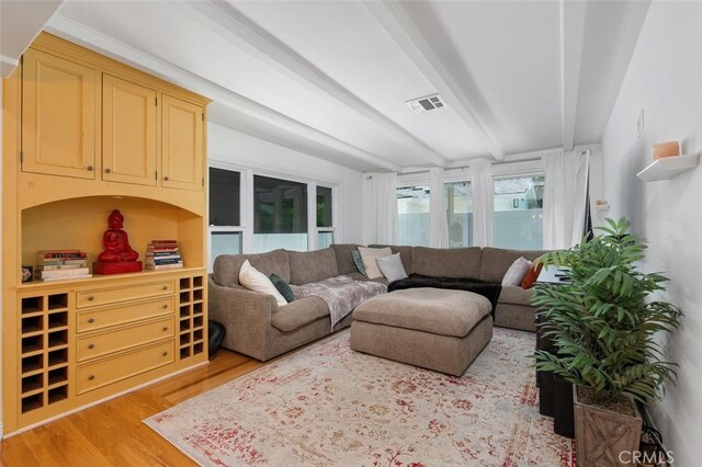 12424 Sarah St, Studio City, CA 91604 - living area with beamed ceiling and light wood-style flooring