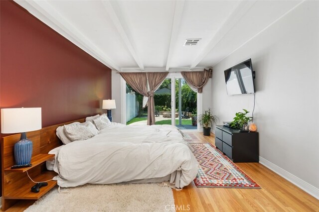 12424 Sarah St, Studio City, CA 91604 - bedroom featuring access to exterior, beam ceiling, and wood finished floors