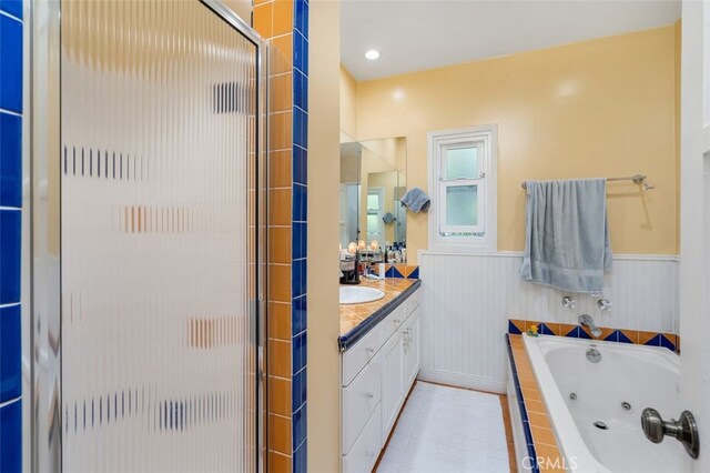 12424 Sarah St, Studio City, CA 91604 - bathroom with a stall shower, a jetted tub, vanity, and wainscoting