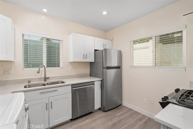 12424 Sarah St, Studio City, CA 91604 - kitchen featuring appliances with stainless steel finishes, light countertops, light wood-style floors, white cabinetry, and recessed lighting