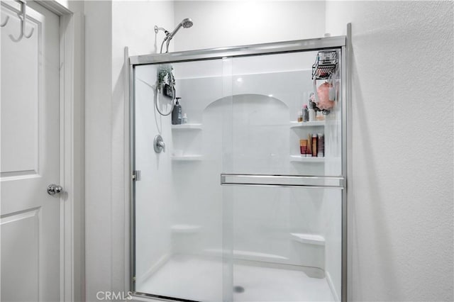 12366 Ranchito Way, Victorville, CA 92392 - bathroom featuring a stall shower and a textured wall