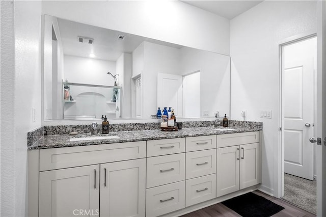 12366 Ranchito Way, Victorville, CA 92392 - bathroom with double vanity, wood finished floors, and a shower
