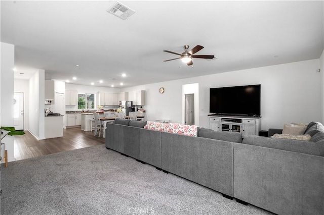 12366 Ranchito Way, Victorville, CA 92392 - living area featuring ceiling fan, recessed lighting, dark colored carpet, and dark wood-type flooring