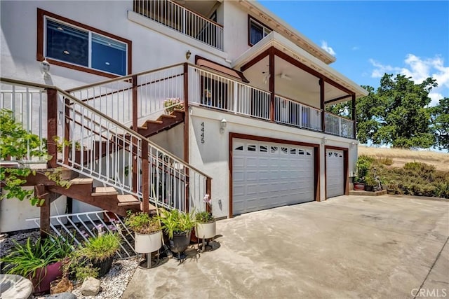 4445 Eucalyptus Ave, Lakeport, CA 95453 - view of side of home featuring a balcony, a garage, driveway, and stucco siding