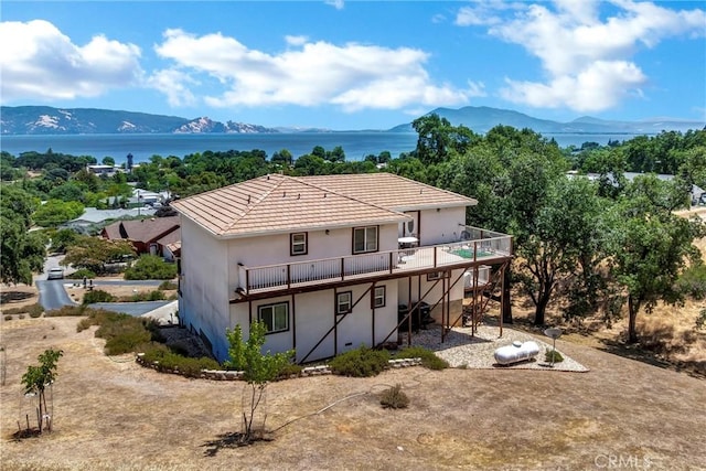 4445 Eucalyptus Ave, Lakeport, CA 95453 - back of property featuring stucco siding, a deck with water view, and a tiled roof