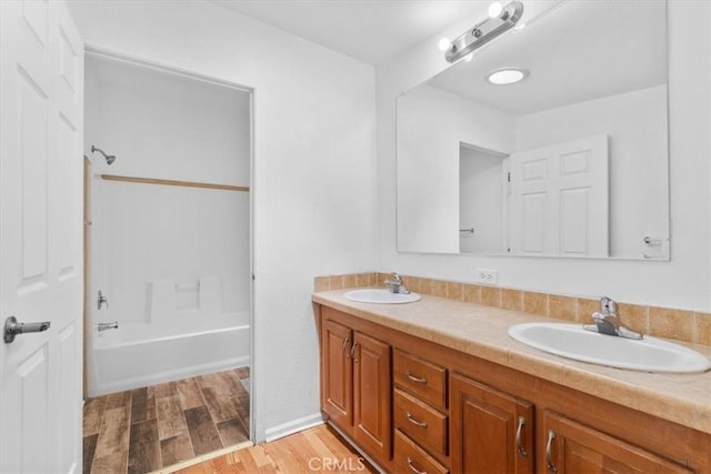 1225 N Alessandro St, Banning, CA 92220 - full bath with double vanity, wood finished floors, and shower / tub combination