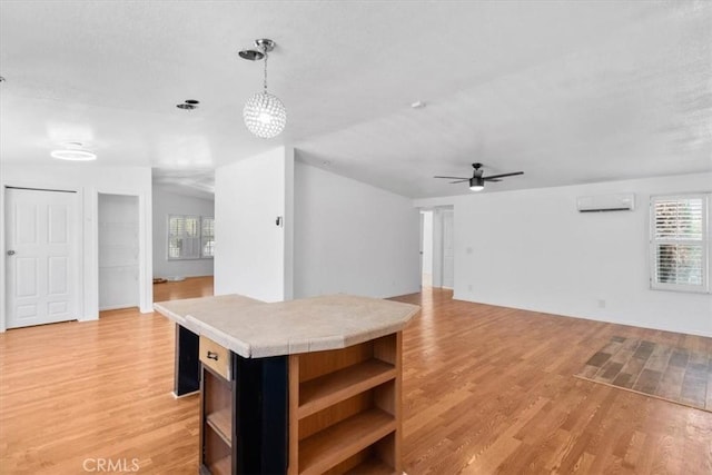1225 N Alessandro St, Banning, CA 92220 - unfurnished living room featuring a wall unit AC, a ceiling fan, and light wood finished floors