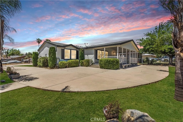 1225 N Alessandro St, Banning, CA 92220 - view of front of property featuring driveway, a sunroom, and a yard