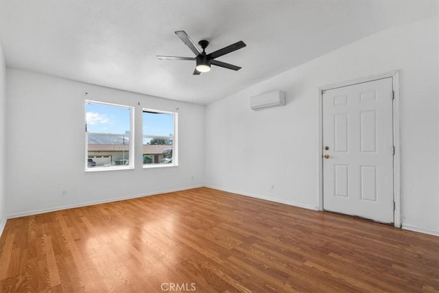 1225 N Alessandro St, Banning, CA 92220 - spare room with a wall unit AC, a ceiling fan, and wood finished floors