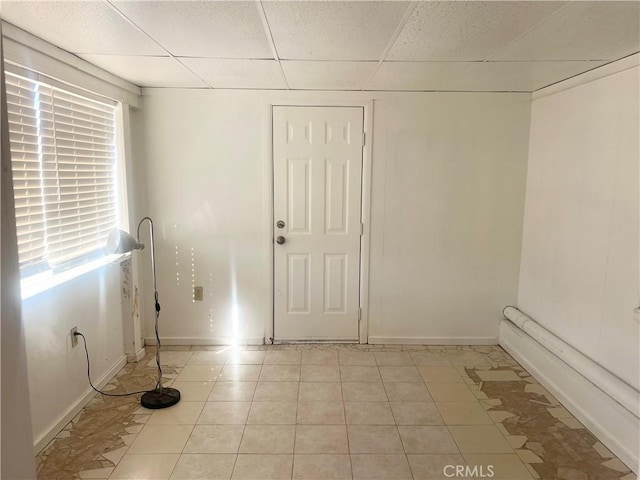 6124 El Reposo St, Joshua Tree, CA 92252 - spare room featuring a drop ceiling and light tile patterned floors