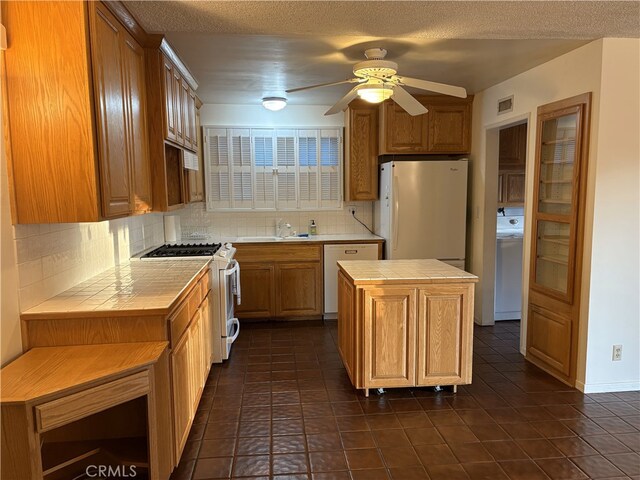 6621 Berquist Ave, West Hills, CA 91307 - kitchen with tile countertops, white appliances, decorative backsplash, and a textured ceiling