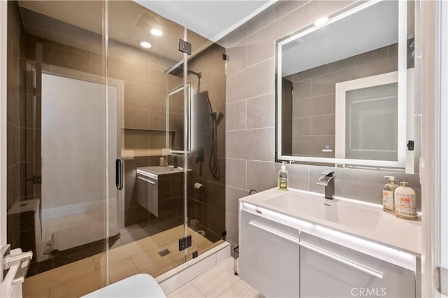 3856 Vista Linda Dr, Encino, CA 91316 - bathroom with tile walls, vanity, a stall shower, and tile patterned flooring
