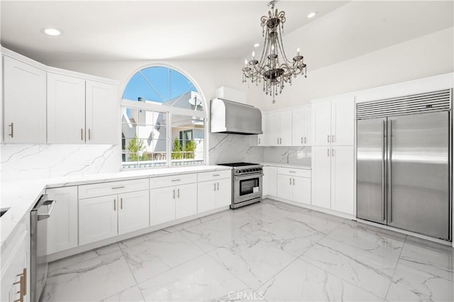 3856 Vista Linda Dr, Encino, CA 91316 - kitchen with high quality appliances, wall chimney range hood, a chandelier, recessed lighting, and white cabinets
