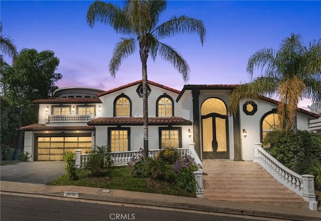 3856 Vista Linda Dr, Encino, CA 91316 - mediterranean / spanish-style house with stucco siding, a garage, asphalt driveway, and a tile roof