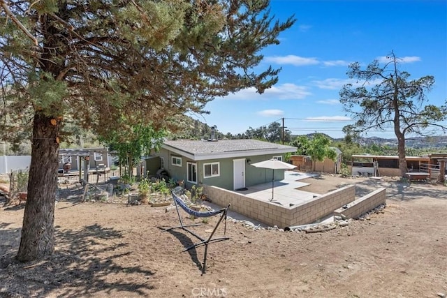 1946 Desert Front Rd, Wrightwood, CA 92397 - rear view of house with stucco siding and a patio area