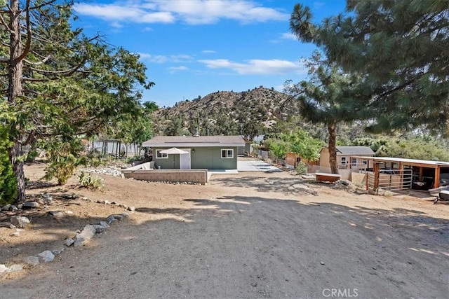 1946 Desert Front Rd, Wrightwood, CA 92397 - view of front facade with a mountain view and an outbuilding
