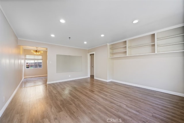800 N Eucalyptus Ave Unit 108, Inglewood, CA 90302 - empty room with wood finished floors, a chandelier, crown molding, recessed lighting, and a pendent fire sprinkler
