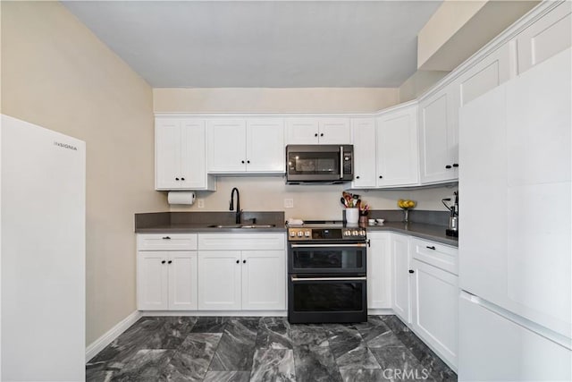 800 N Eucalyptus Ave Unit 108, Inglewood, CA 90302 - kitchen featuring stainless steel microwave, range with two ovens, freestanding refrigerator, and dark countertops