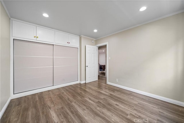 800 N Eucalyptus Ave Unit 108, Inglewood, CA 90302 - unfurnished bedroom featuring ornamental molding, wood finished floors, recessed lighting, and a closet