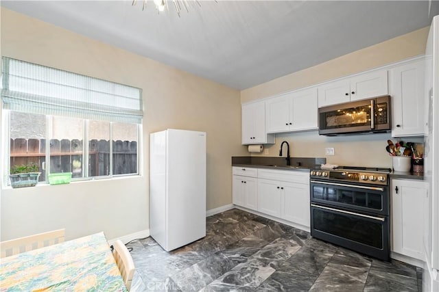 800 N Eucalyptus Ave Unit 108, Inglewood, CA 90302 - kitchen featuring stainless steel microwave, double oven range, freestanding refrigerator, dark countertops, and white cabinets
