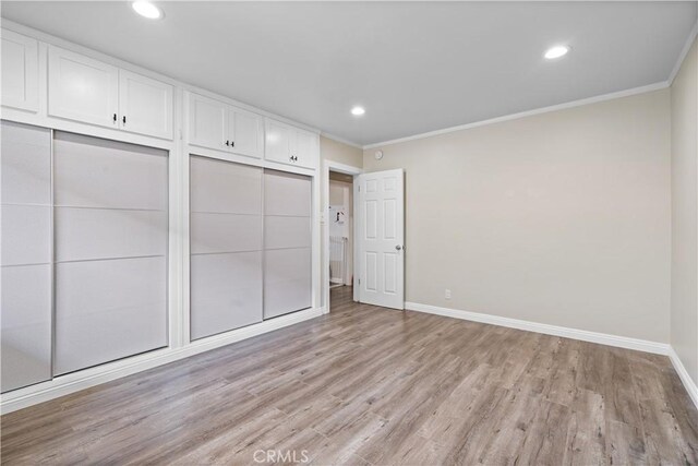 800 N Eucalyptus Ave Unit 108, Inglewood, CA 90302 - unfurnished bedroom featuring crown molding, light wood-type flooring, and recessed lighting