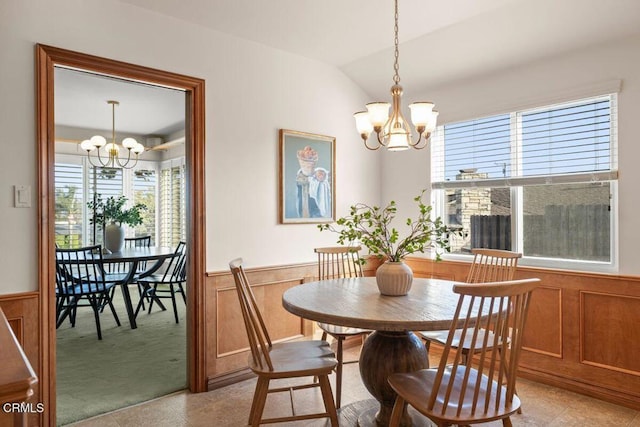 410 Palomares Ave, Ventura, CA 93003 - dining space with a chandelier, wainscoting, healthy amount of natural light, lofted ceiling, and light carpet
