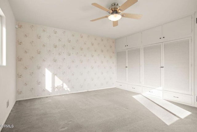 410 Palomares Ave, Ventura, CA 93003 - unfurnished bedroom featuring carpet floors, wallpapered walls, a ceiling fan, and a closet