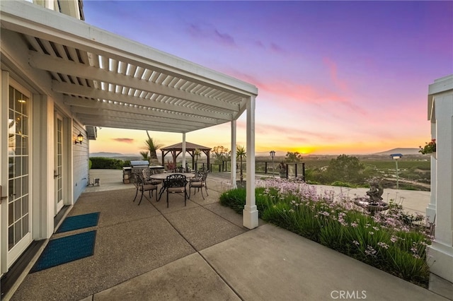 40115 Via Cordova, Temecula, CA 92592 - patio terrace at dusk with a patio, a pergola, and outdoor dining space