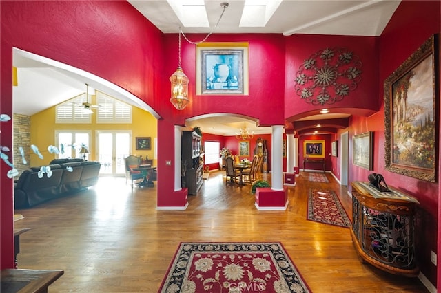 40115 Via Cordova, Temecula, CA 92592 - entrance foyer featuring ornate columns, arched walkways, wood finished floors, ceiling fan, and a towering ceiling