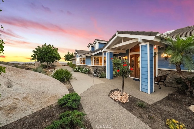 40115 Via Cordova, Temecula, CA 92592 - property exterior at dusk featuring stone siding and a tile roof