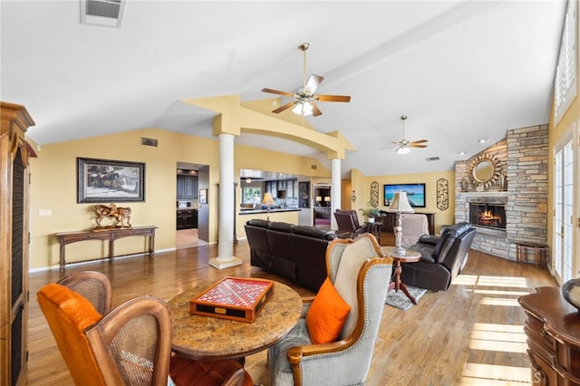 40115 Via Cordova, Temecula, CA 92592 - living room with lofted ceiling, a stone fireplace, ornate columns, ceiling fan, and light wood-style floors