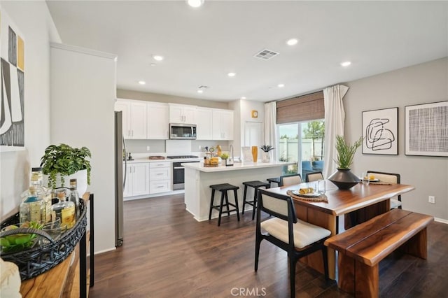 14180 Astra St, Moreno Valley, CA 92555 - dining area featuring dark wood finished floors and recessed lighting