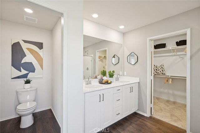 14180 Astra St, Moreno Valley, CA 92555 - bathroom with double vanity, a walk in closet, wood finished floors, and recessed lighting