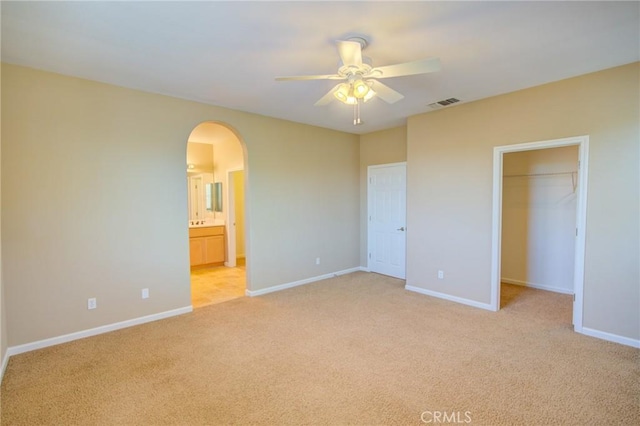 518 Barclay Way, Merced, CA 95348 - unfurnished bedroom with arched walkways, light colored carpet, a spacious closet, and ensuite bathroom