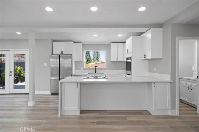 837 S Magnolia Ave, Anaheim, CA 92804 - kitchen featuring stainless steel appliances, white cabinets, light countertops, a peninsula, and recessed lighting