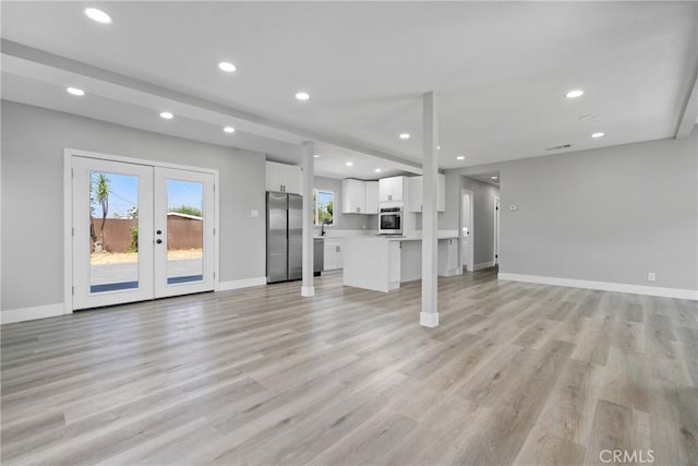 837 S Magnolia Ave, Anaheim, CA 92804 - unfurnished living room featuring french doors, recessed lighting, and light wood-type flooring